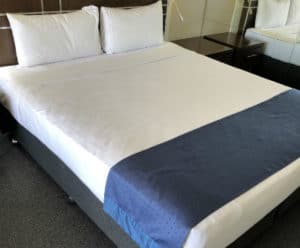 A bed inside a hotel with a good mattress.
