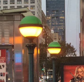 The green ball lights which indicate where subway entrances are.